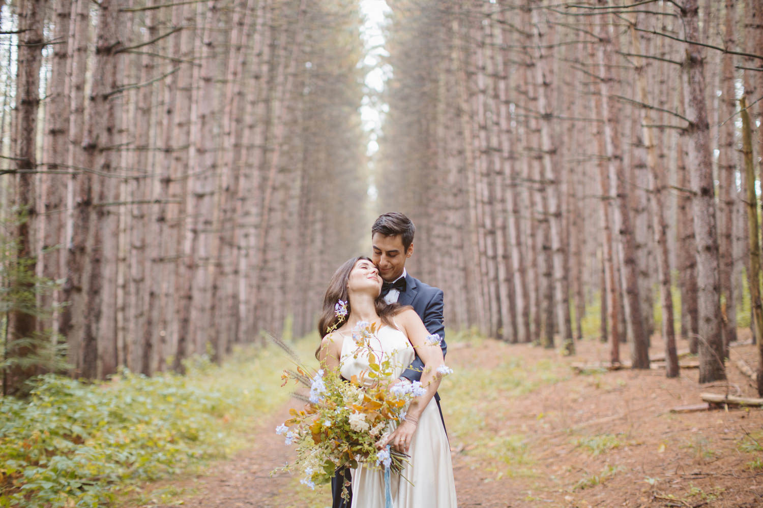 Bride and groom in forest at upcountry venue