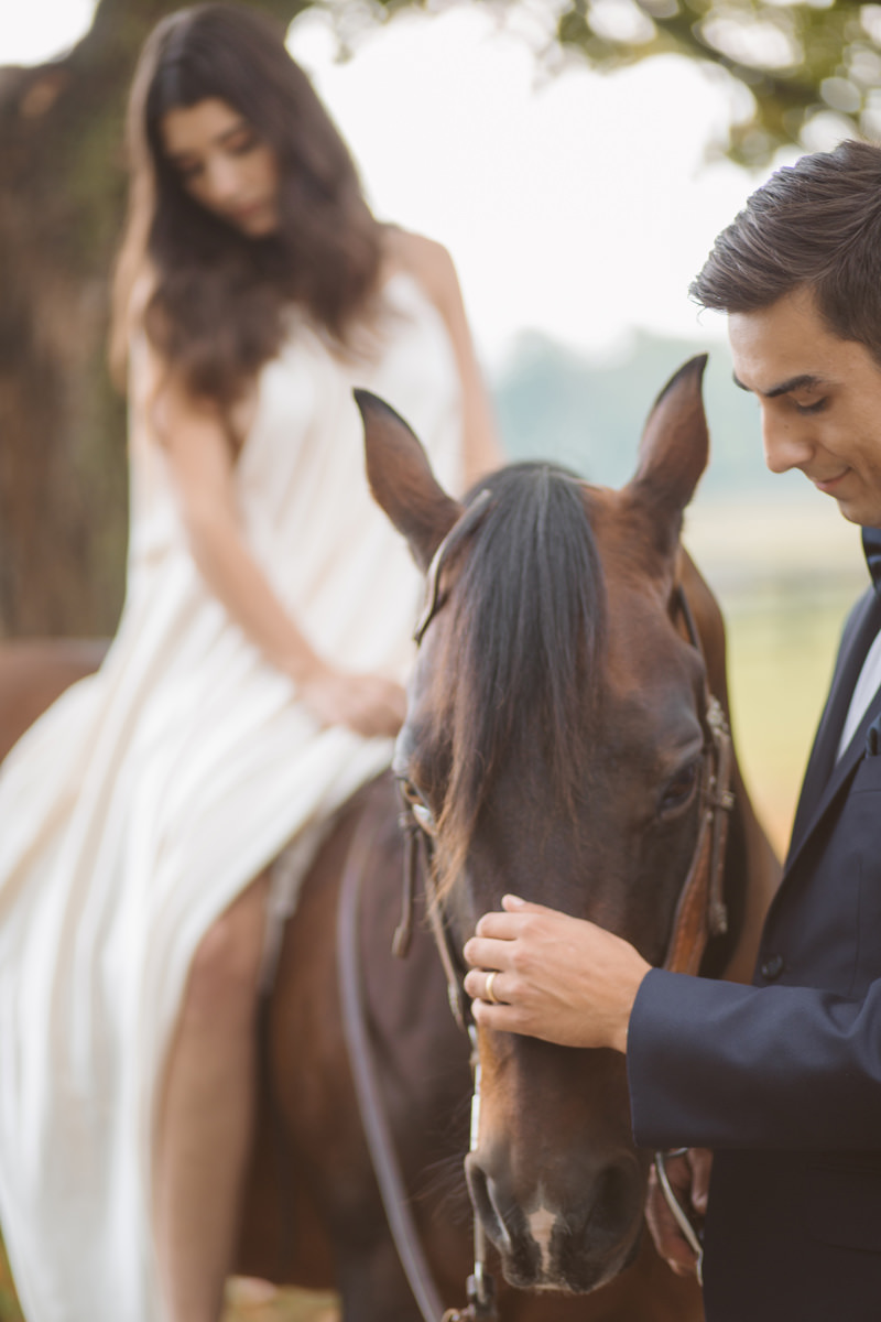 Bride riding horse with groom at Upcountry venue